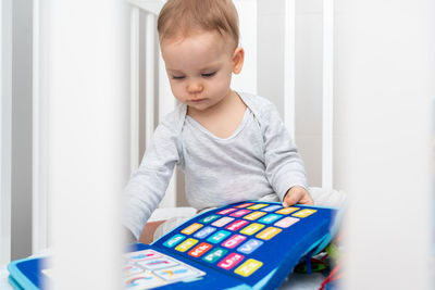 Boy playing with toy blocks at home