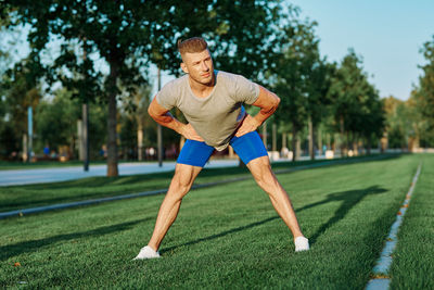 Young man exercising on field