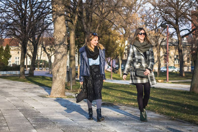 Full length of woman in park in city