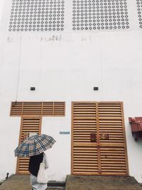 Rear view of man against building