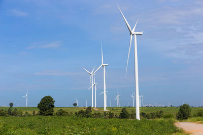 Windmill on field against sky