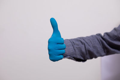 Close-up of human hand against white background