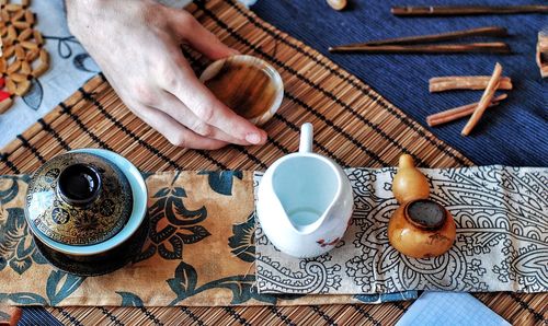 High angle view of woman and coffee cup on table