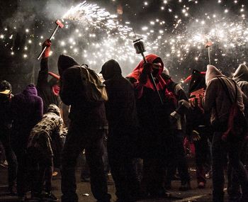 Crowd in hooded shirts enjoying rock music at concert