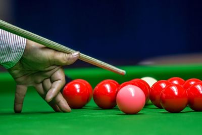 Cropped hand of man playing snooker