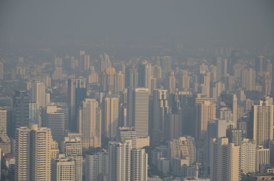 Aerial view of modern buildings in city against sky