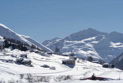 Scenic view of snowcapped mountains against clear sky