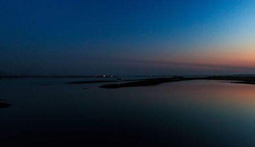 Scenic view of sea against clear sky at sunset