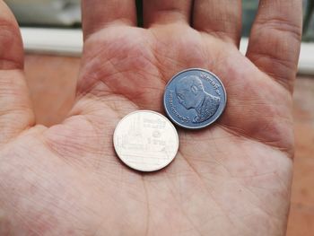 Close-up of hand holding coins