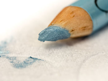 Extreme close-up of eyeliner pencil on table