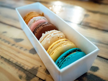 High angle view of macaroons in box on table