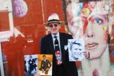 Portrait of a young man standing against graffiti