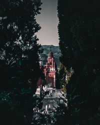 Low angle view of trees and buildings against sky