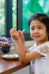 Portrait of cute girl on table