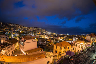 High angle view of illuminated townscape against sky at night