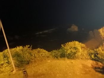 Scenic view of field against sky at night