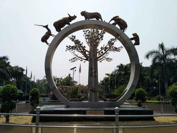 Metallic structure in park against sky