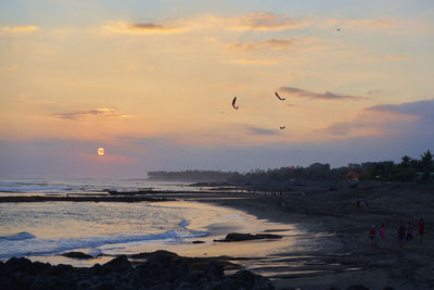 Scenic view of beach against sky during sunset