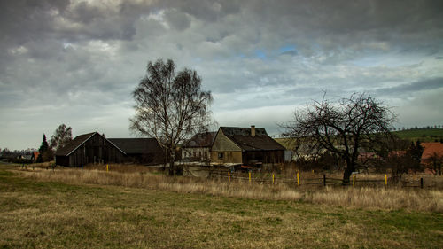 Houses on field against sky