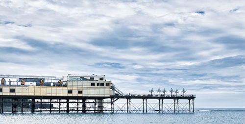 Pier by sea against sky
