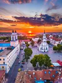 High angle view of buildings in city at sunset