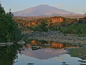 Scenic view of river and mountain against sky