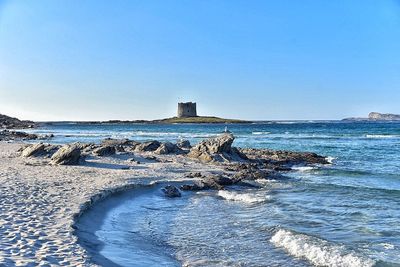 Scenic view of sea against clear blue sky