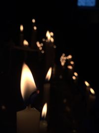 Close-up of lit candle in dark room
