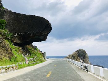 Road by sea against sky