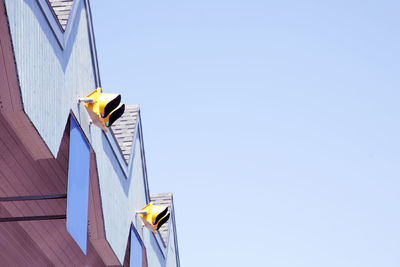 Low angle view of yellow flag against clear sky