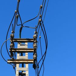 Power line against clear blue sky