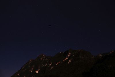 Low angle view of mountain against sky at night