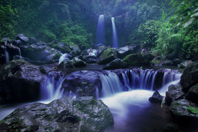Water flow and cool waterfalls in the forest. grenjengan kembar waterfall in magelang, central java
