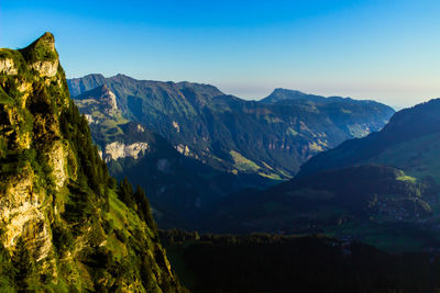 Scenic view of mountains against clear blue sky