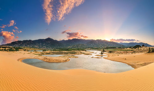 Panoramic view of beach against sky during sunset