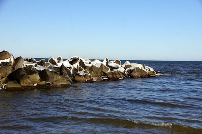 Scenic view of sea against clear blue sky