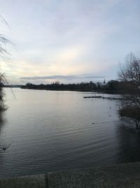 Scenic view of lake against sky at sunset