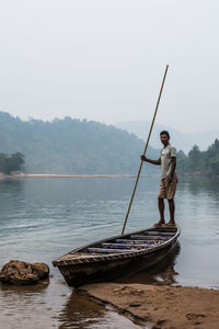 Man standing in lake against clear sky