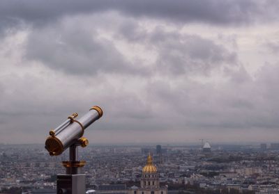 Cityscape against cloudy sky