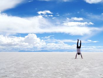 Rear view of woman walking on beach