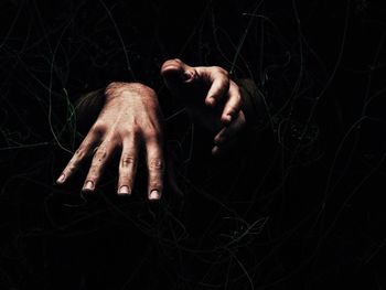 Close-up of hands over black background