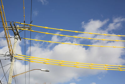 Low angle view of cables against blue sky