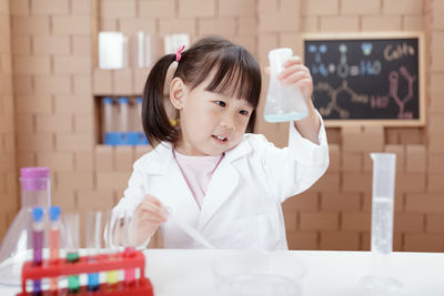 Young girl play science experiments for homeschooling
