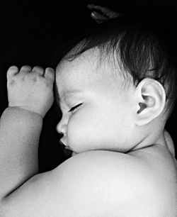 Close-up of cute baby sleeping on bed