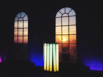Illuminated building seen through window