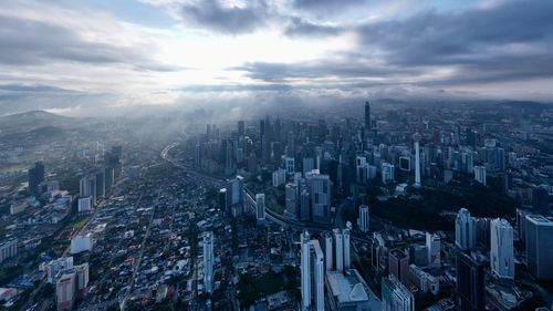 High angle view of modern buildings in city against sky