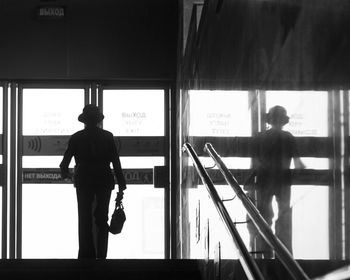 Silhouette people walking on railroad station platform