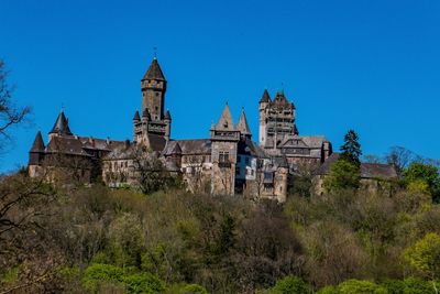 Low angle view of historical building against clear blue sky