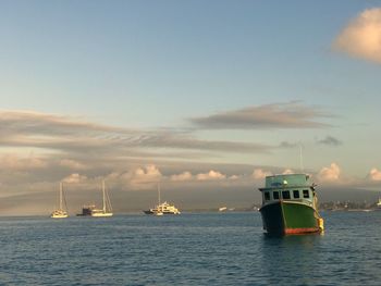 Ship sailing in sea against sky