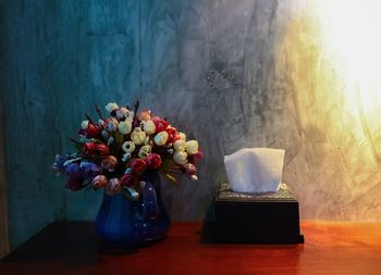 Close-up of flower vase on table at home